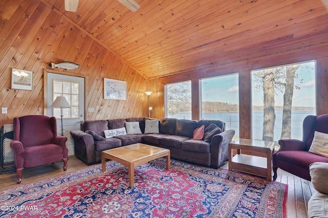 living room featuring hardwood / wood-style flooring, wood walls, wooden ceiling, and vaulted ceiling