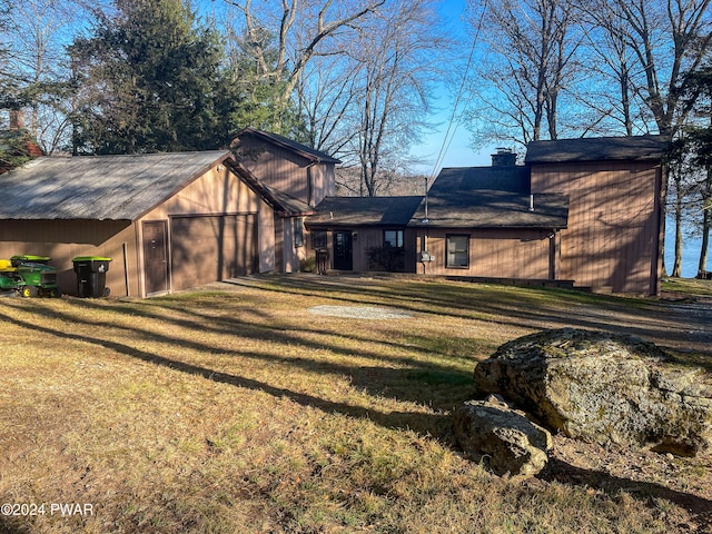 rear view of property with a lawn