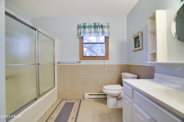 full bathroom featuring a baseboard radiator, tile patterned flooring, bath / shower combo with glass door, toilet, and vanity