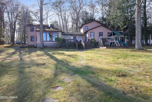 view of yard with a playground and a deck