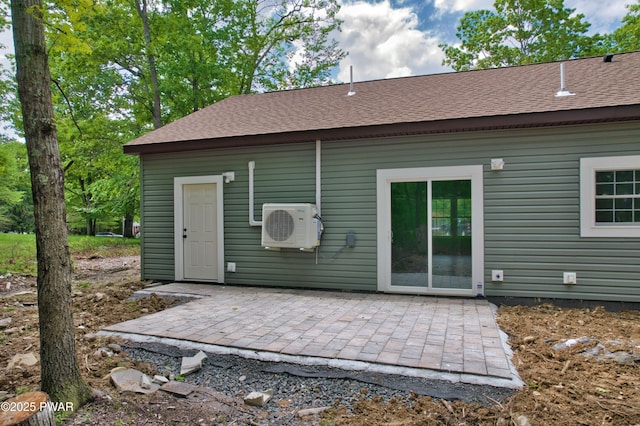 209 Bindale Rd, Tamiment, PA 18324 - rear view of house featuring a cooling unit, a patio area, and roof with shingles