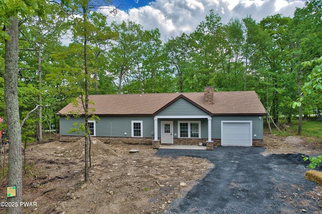 209 Bindale Rd, Tamiment, PA 18324 - ranch-style house with a garage, a chimney, asphalt driveway, and a shingled roof