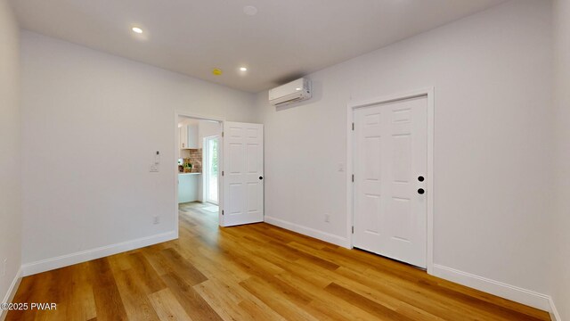 209 Bindale Rd, Tamiment, PA 18324 - spare room featuring an AC wall unit, light wood finished floors, baseboards, and recessed lighting