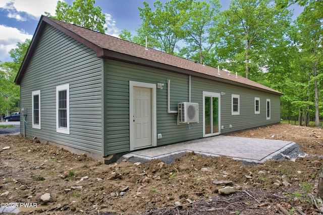 209 Bindale Rd, Tamiment, PA 18324 - back of property with a patio, ac unit, and a shingled roof