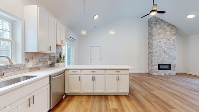209 Bindale Rd, Tamiment, PA 18324 - kitchen featuring stainless steel dishwasher, a wall mounted AC, a peninsula, ceiling fan, and a sink