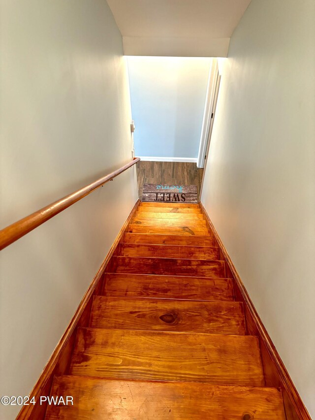 staircase with wood-type flooring