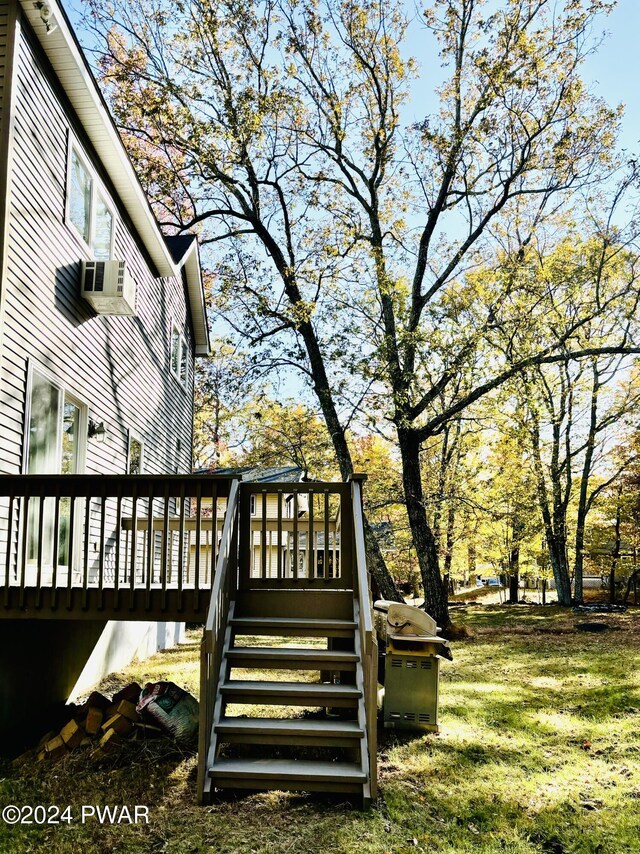 wooden terrace featuring a yard