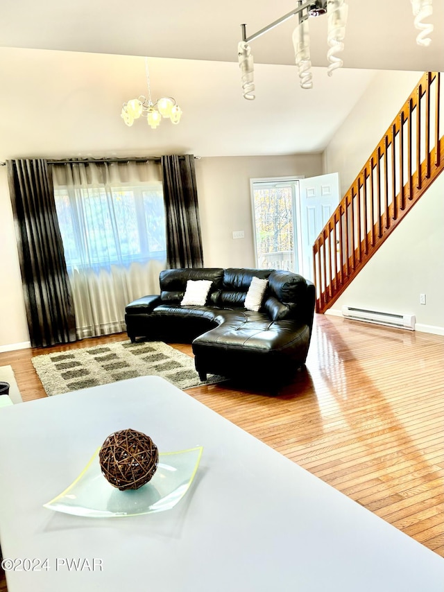 living room featuring a chandelier, hardwood / wood-style floors, and baseboard heating