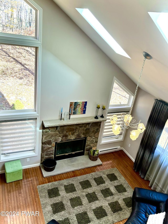 living room featuring a fireplace, a baseboard radiator, lofted ceiling, and hardwood / wood-style flooring