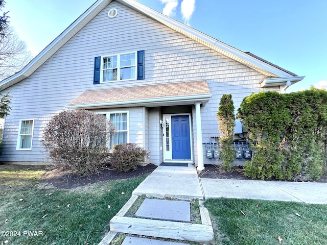 view of property featuring a front lawn