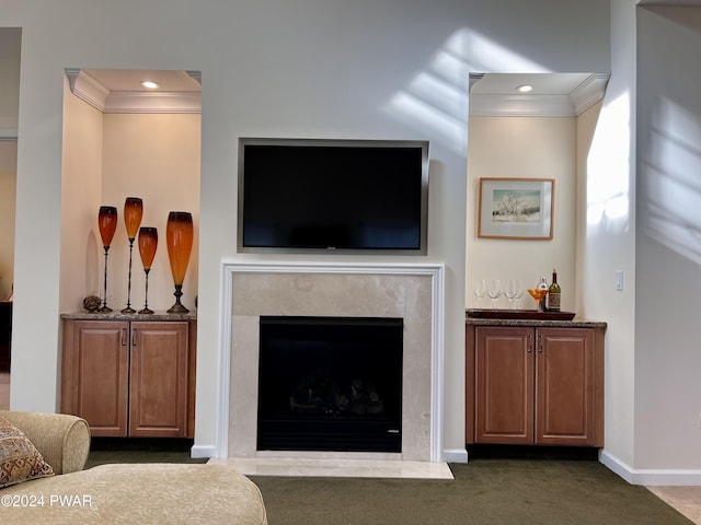 carpeted living room featuring ornamental molding and a premium fireplace