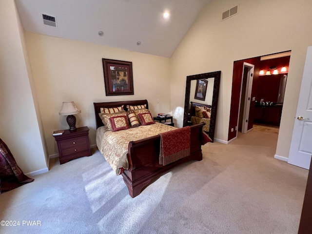 carpeted bedroom with high vaulted ceiling