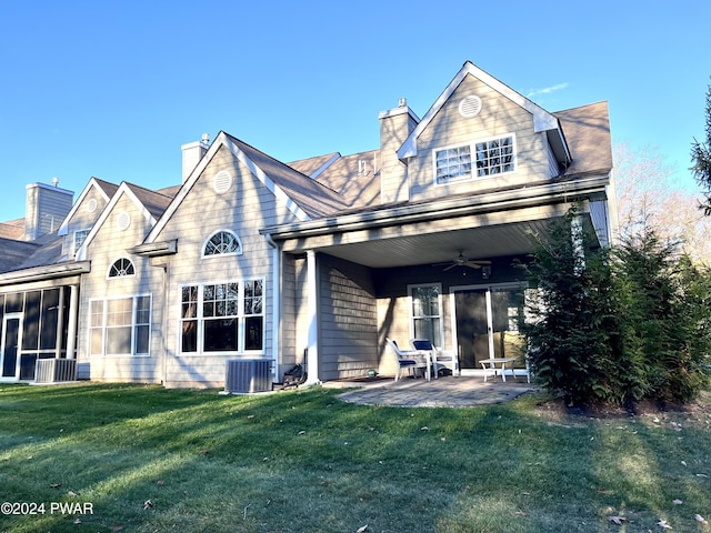 rear view of house with a lawn, ceiling fan, cooling unit, and a patio area