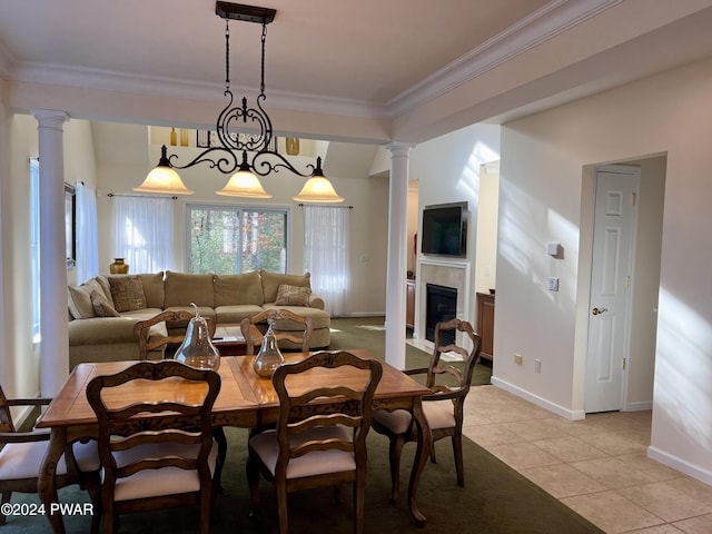 dining space with a notable chandelier, light tile patterned floors, and ornamental molding