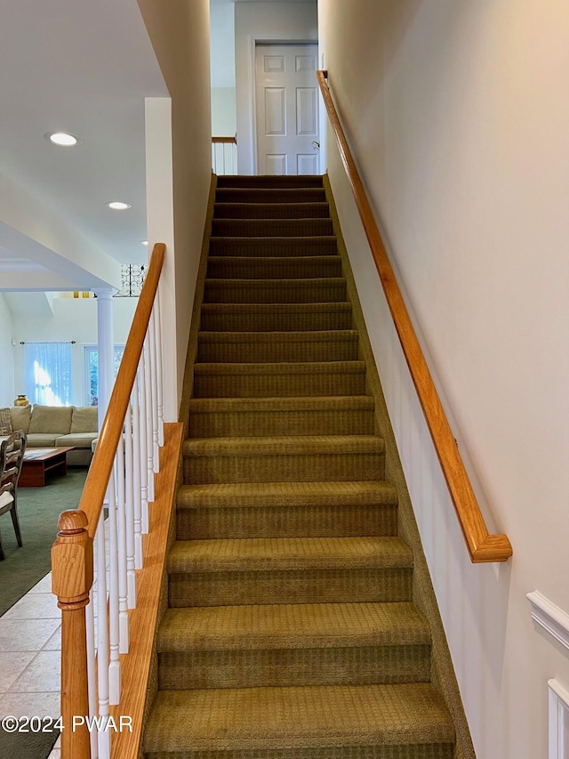 stairs featuring tile patterned floors