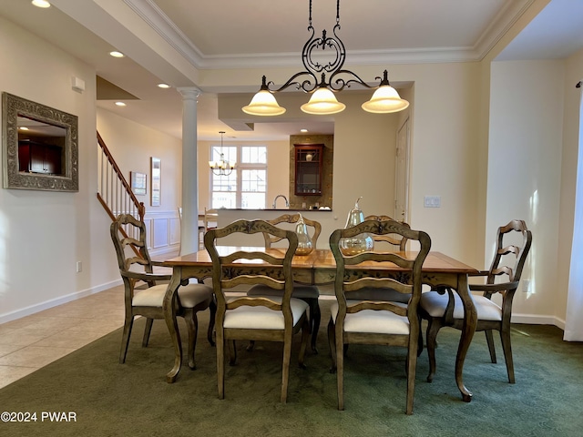 tiled dining area with a notable chandelier, ornate columns, and crown molding