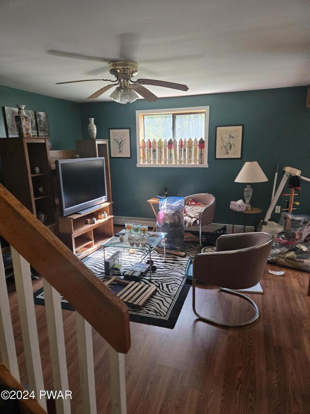 living room featuring ceiling fan and hardwood / wood-style floors