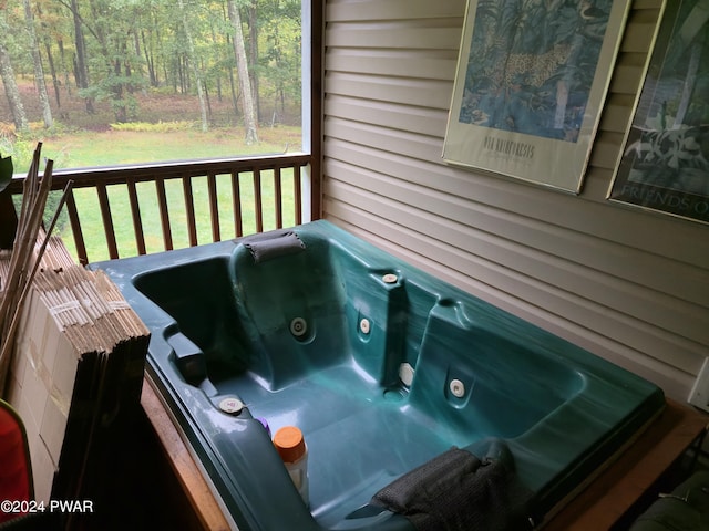 wooden terrace featuring a yard and a hot tub