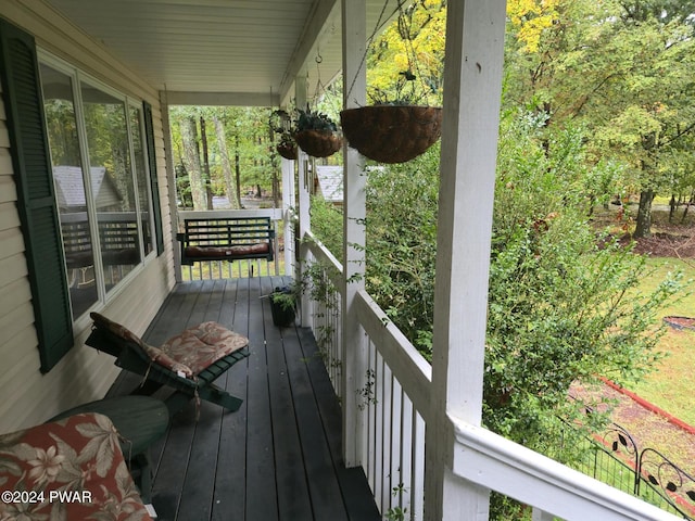 wooden terrace featuring covered porch