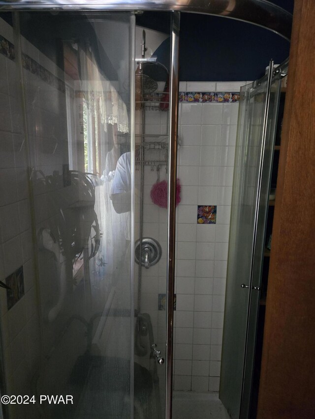 bathroom with a shower with door