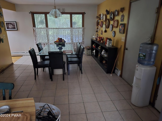 dining area featuring light tile patterned floors and a baseboard radiator