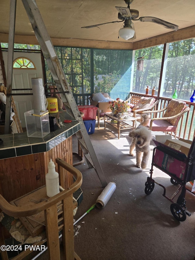 sunroom / solarium featuring ceiling fan