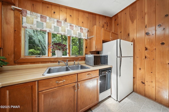 201 Oak Hill Rd, Hawley, PA 18428 - kitchen featuring stainless steel microwave, dishwasher, wooden walls, freestanding refrigerator, and light countertops