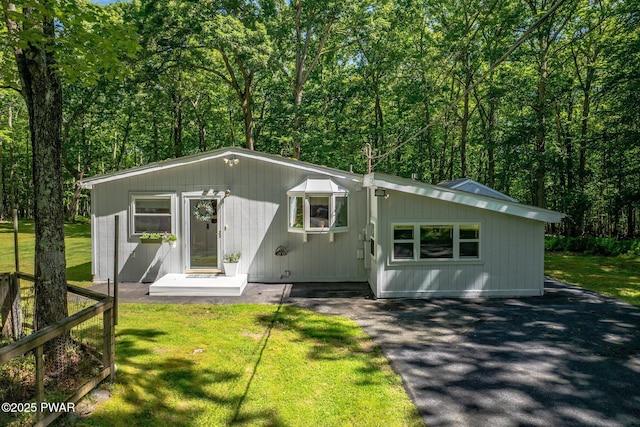 201 Oak Hill Rd, Hawley, PA 18428 - view of front of house with a front yard, asphalt driveway, and a forest view