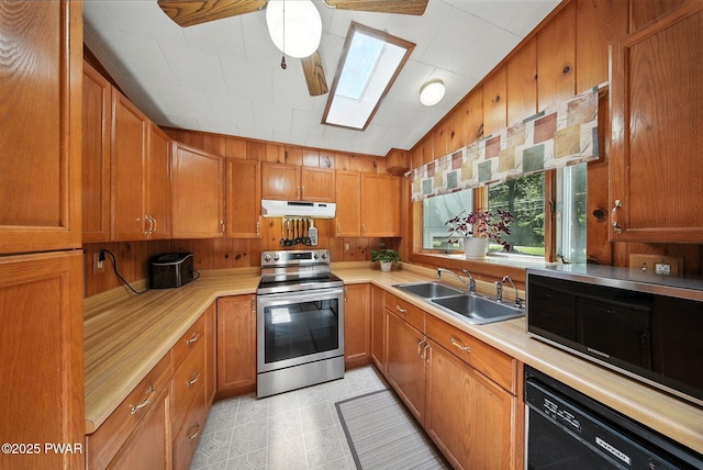 201 Oak Hill Rd, Hawley, PA 18428 - kitchen with electric stove, black dishwasher, under cabinet range hood, a skylight, and light countertops