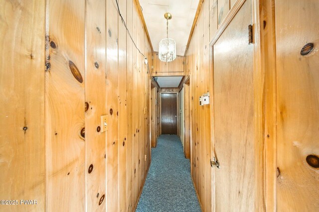 201 Oak Hill Rd, Hawley, PA 18428 - hall with carpet floors, wood walls, and a chandelier