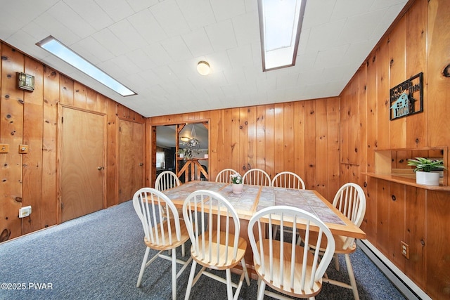 201 Oak Hill Rd, Hawley, PA 18428 - dining room with baseboard heating, carpet, and wood walls