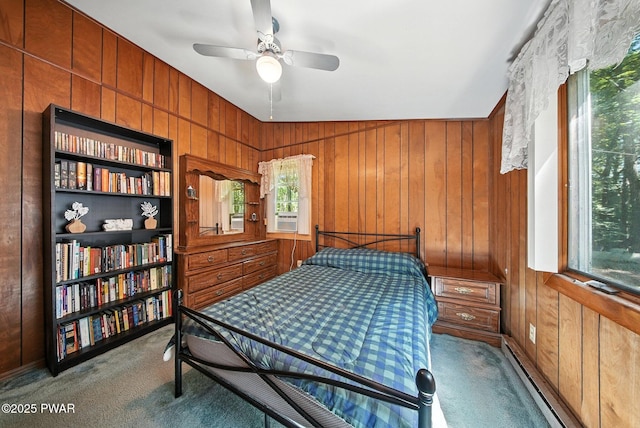 201 Oak Hill Rd, Hawley, PA 18428 - bedroom with carpet floors, a baseboard heating unit, wood walls, and ceiling fan