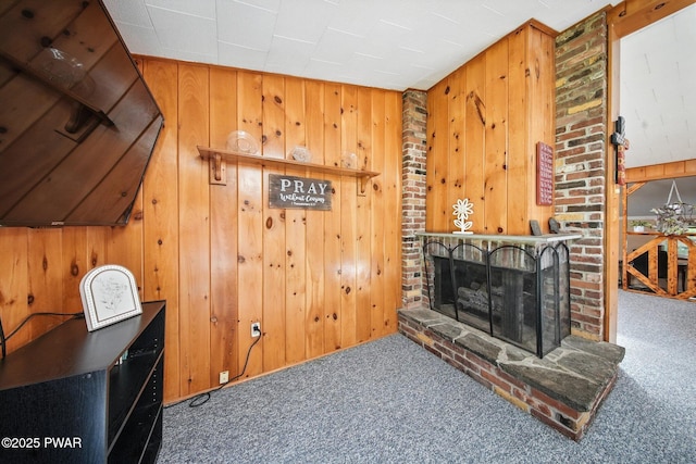 201 Oak Hill Rd, Hawley, PA 18428 - living area featuring carpet, wood walls, and a brick fireplace