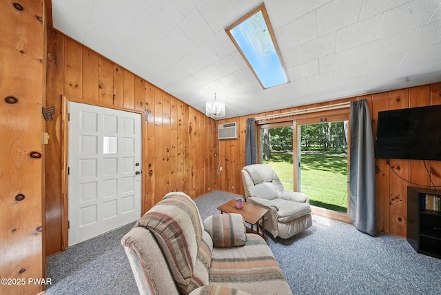 201 Oak Hill Rd, Hawley, PA 18428 - living room with carpet, a wall unit AC, wooden walls, a chandelier, and a skylight
