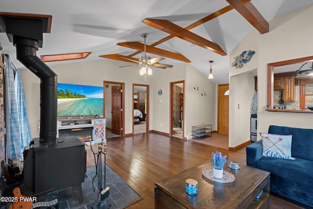 135 Outer Dr, Dingmans Ferry, PA 18328 - living room featuring a ceiling fan, a wood stove, wood-type flooring, and baseboards