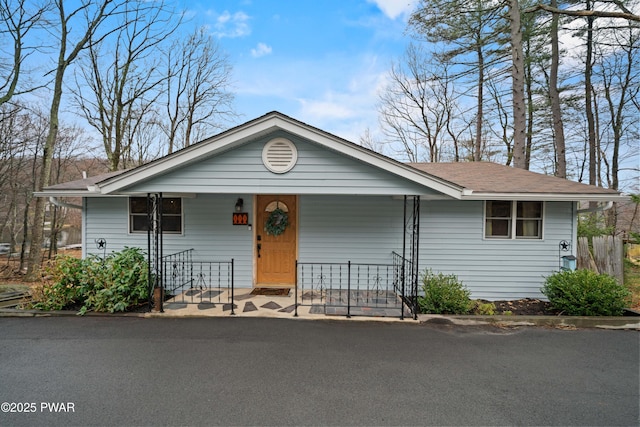 135 Outer Dr, Dingmans Ferry, PA 18328 - view of front facade with a porch and roof with shingles