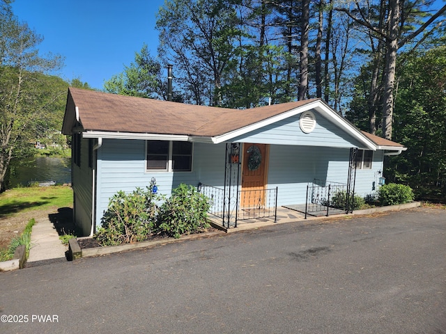 135 Outer Dr, Dingmans Ferry, PA 18328 - view of front of home with covered porch and roof with shingles