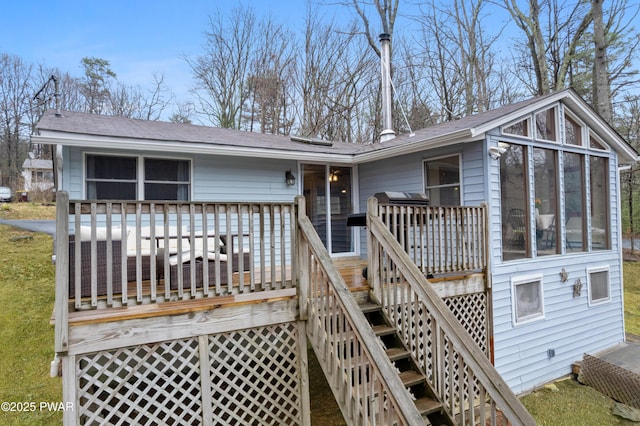 135 Outer Dr, Dingmans Ferry, PA 18328 - back of property featuring stairs, a wooden deck, a sunroom, and a shingled roof