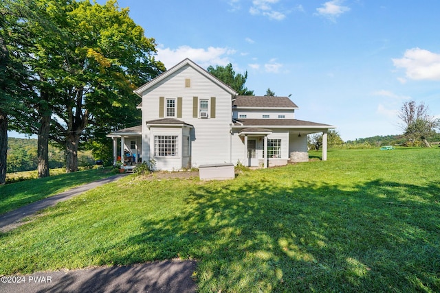 back of house featuring a yard and a porch