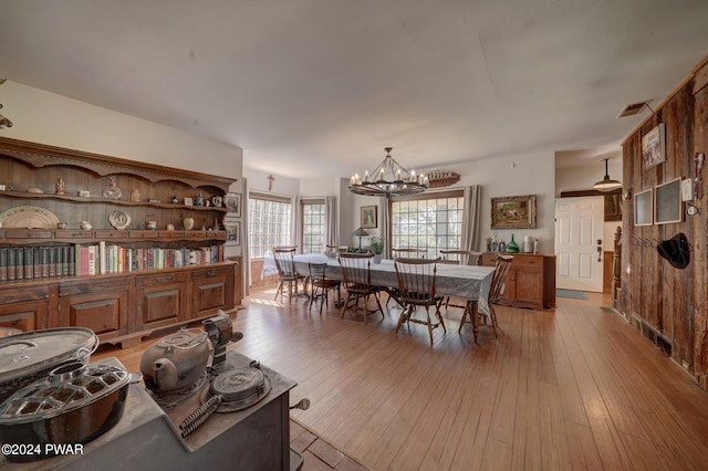 dining area featuring a notable chandelier and light wood-type flooring