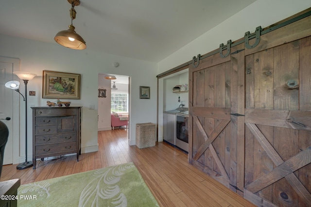 interior space with a barn door and light wood-type flooring