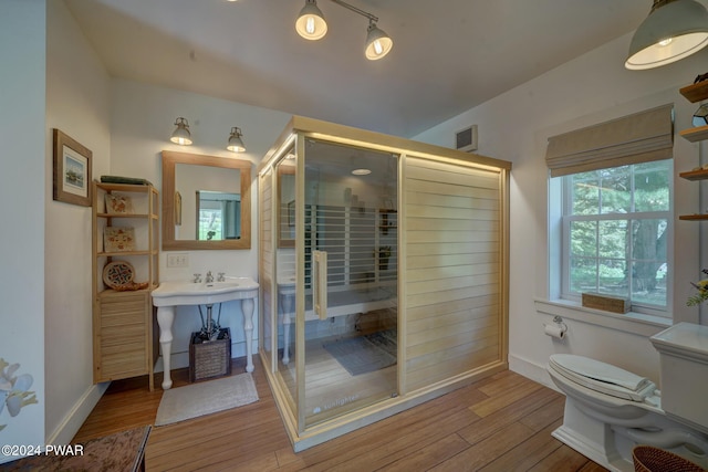 bathroom featuring hardwood / wood-style floors and toilet