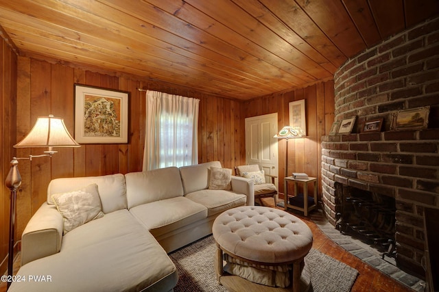 living room featuring wood walls, a fireplace, and wood ceiling