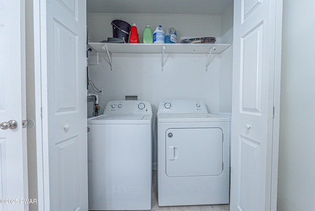 washroom with washing machine and clothes dryer