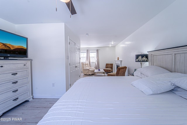 bedroom with ceiling fan and light wood-type flooring