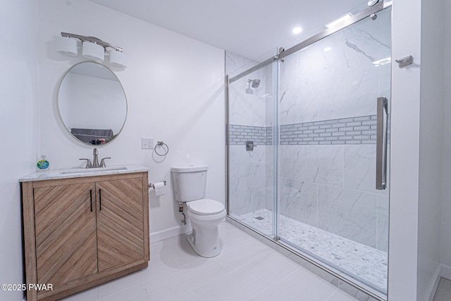 bathroom with vanity, toilet, and a shower with door