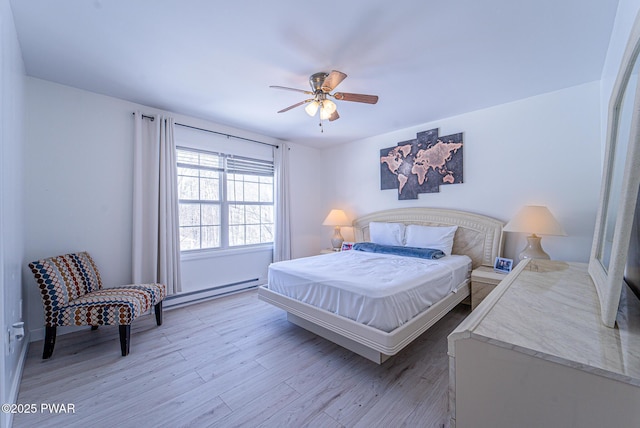 bedroom featuring ceiling fan, a baseboard radiator, and light hardwood / wood-style flooring