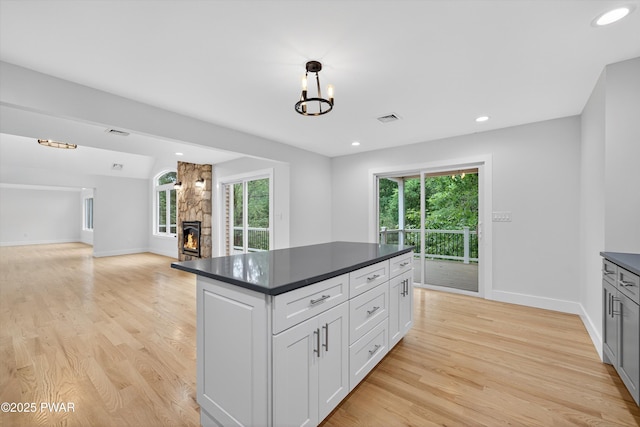 120 Milford Estates Dr, Milford, PA 18337 - kitchen with dark countertops, healthy amount of natural light, light wood-type flooring, white cabinets, and recessed lighting