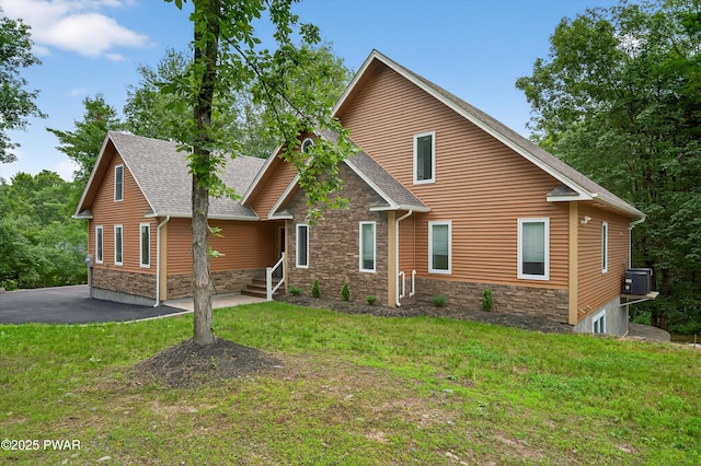 120 Milford Estates Dr, Milford, PA 18337 - view of front of home with stone siding, a front yard, and roof with shingles