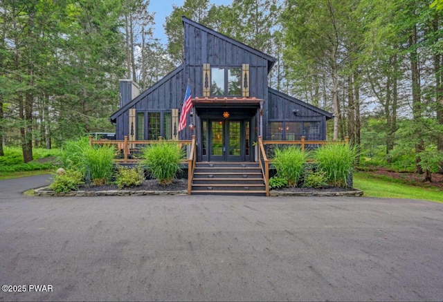 803 Deerfield Rd, Lake Ariel, PA 18436 - modern home featuring board and batten siding, a deck, and a chimney